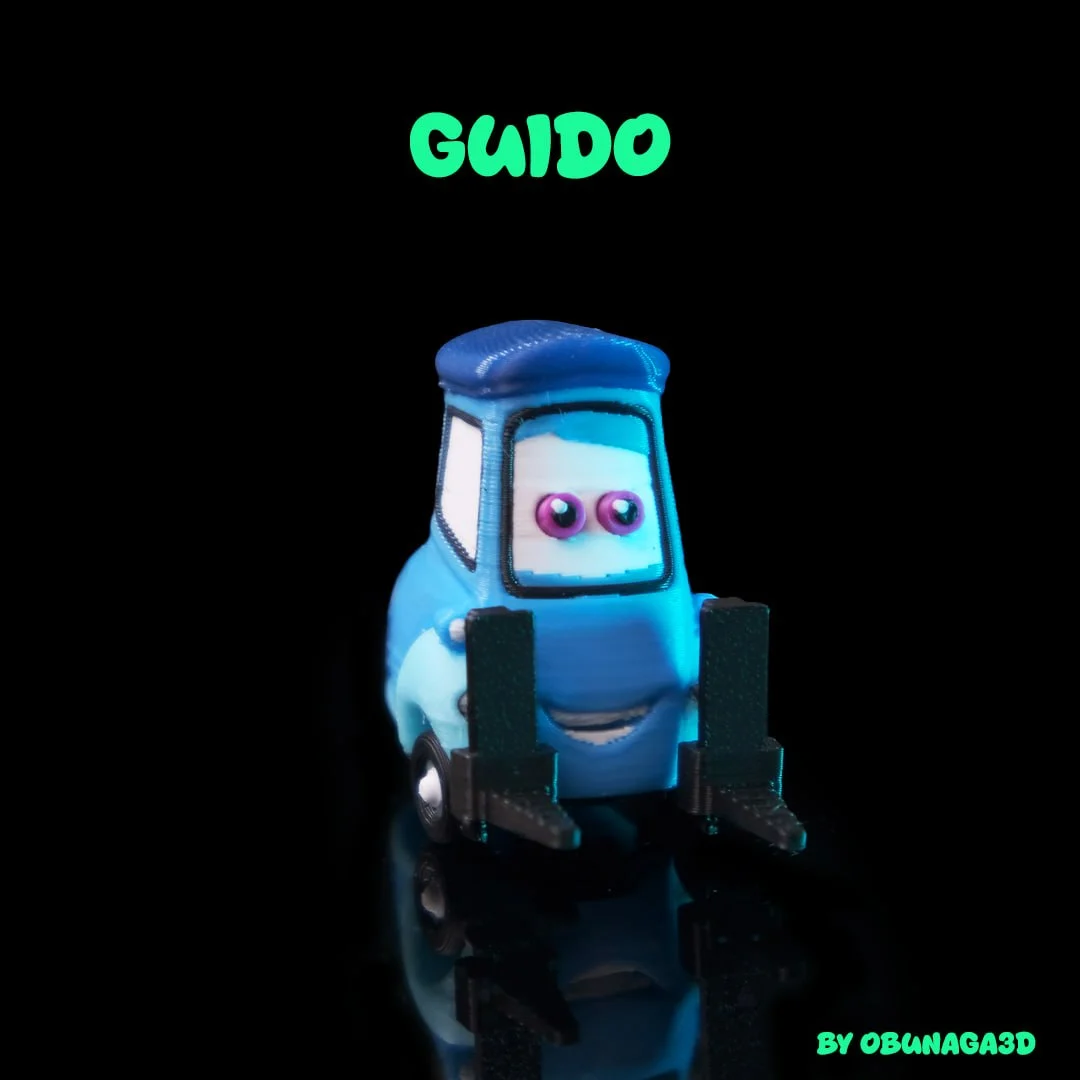 Guido-inspired blue 3D printed forklift figure by Obunaga3D, with expressive windscreen eyes, a smiling face and black forklift prongs